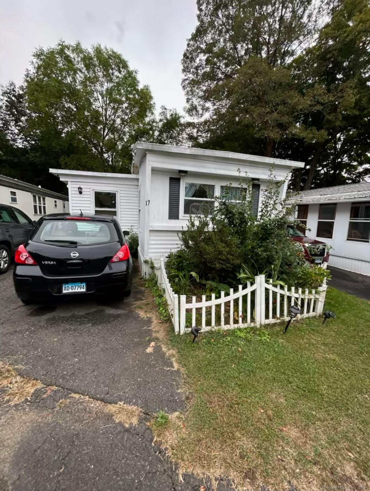 a front view of a house with a garden