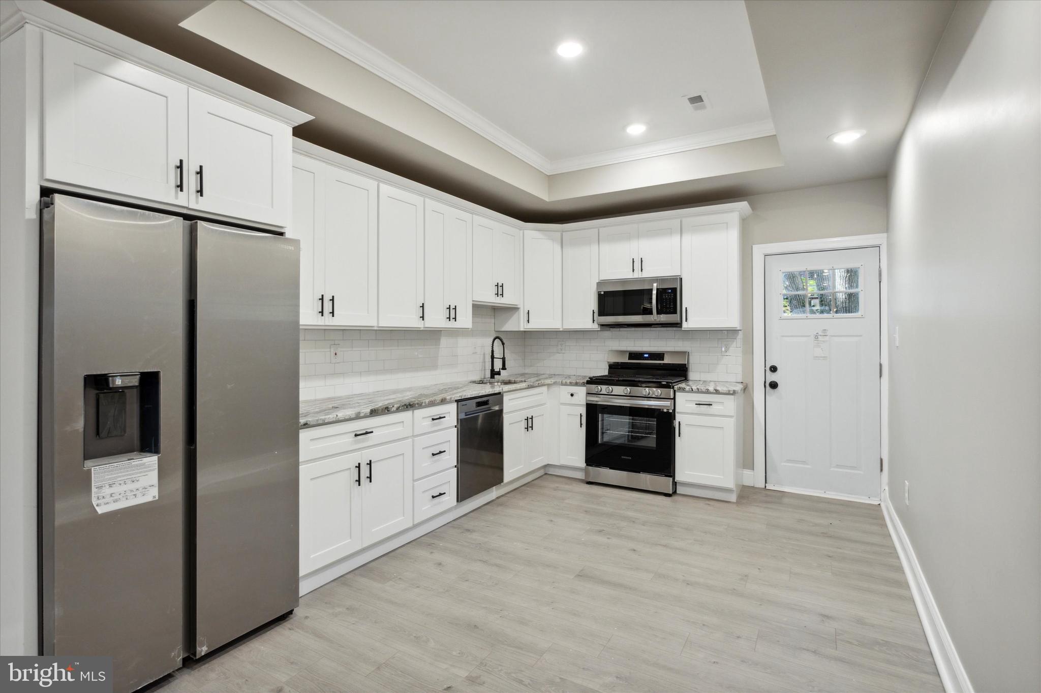 a kitchen with a refrigerator stove and microwave