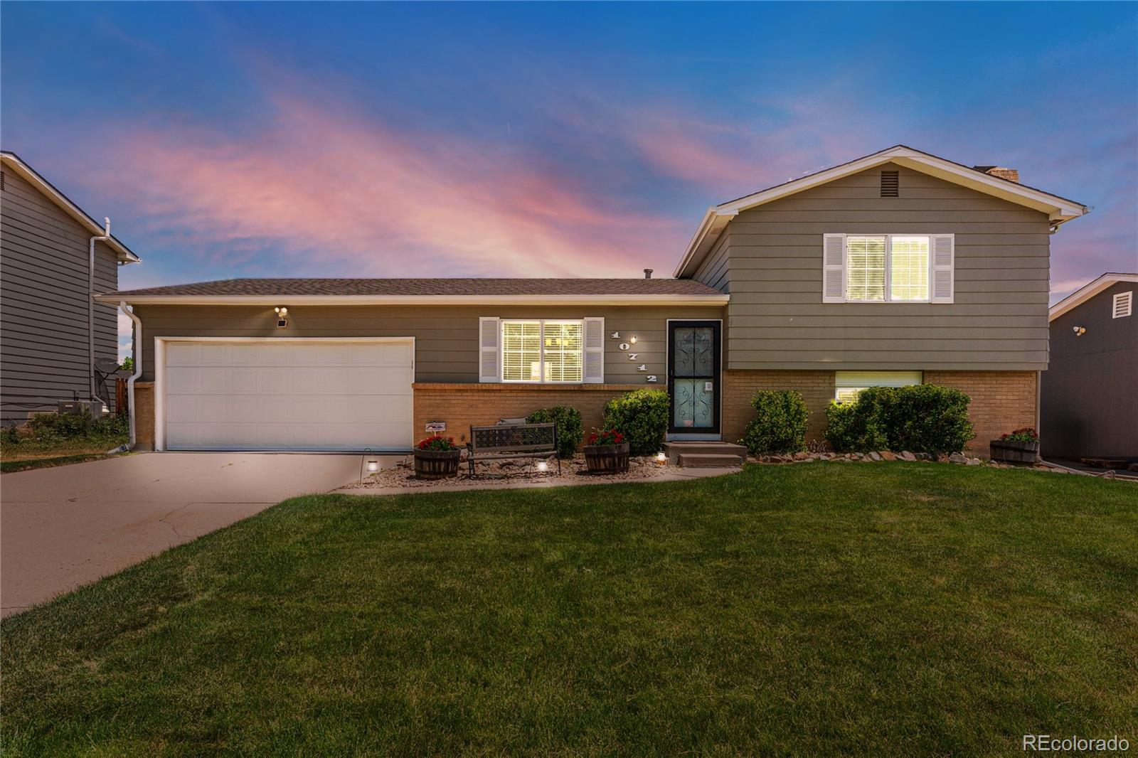 a front view of house with yard and outdoor seating