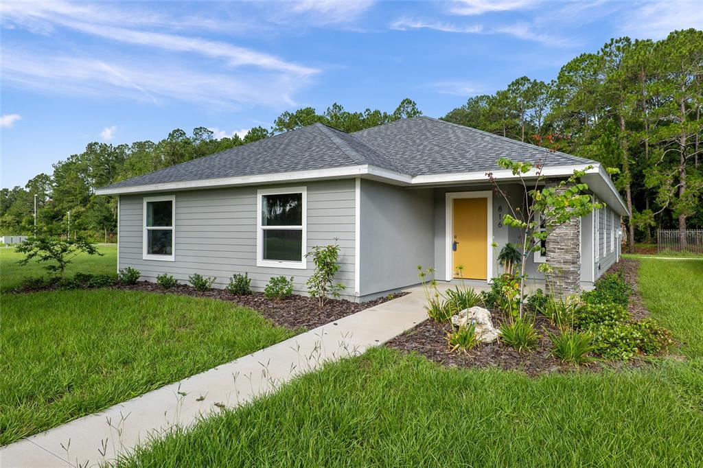 a front view of a house with a garden