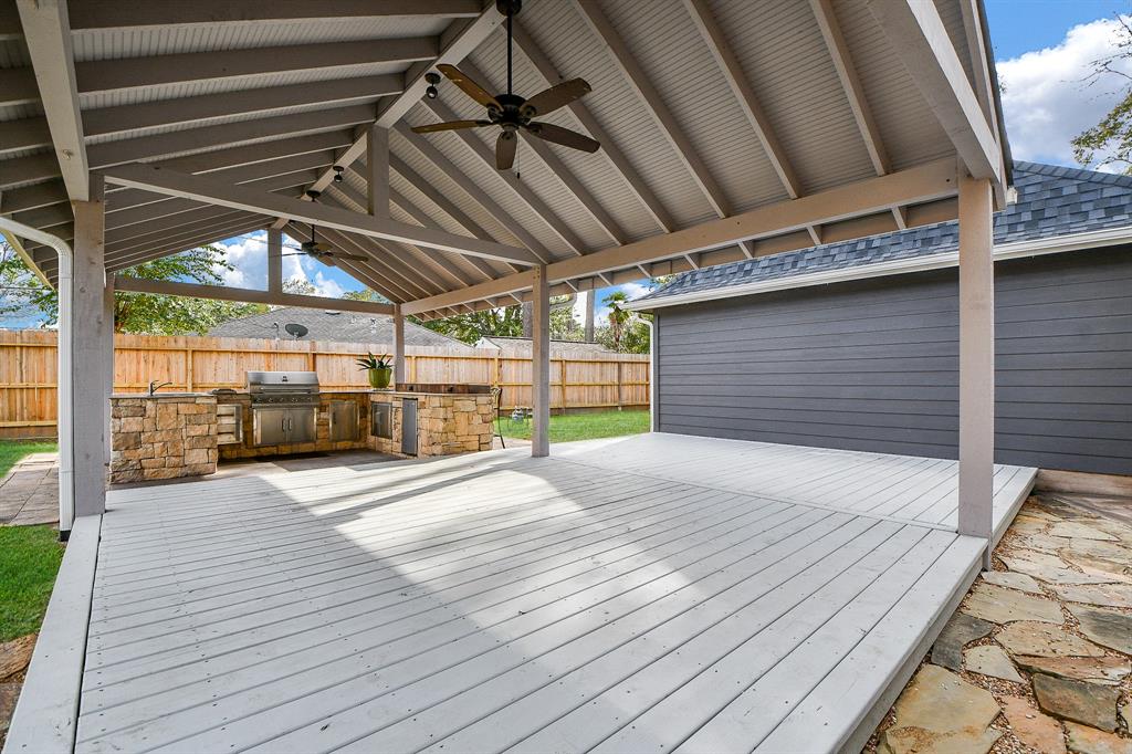 Backyard FUN! Celebrate, relax and enjoy your own backyard living environment. The covered deck features 2 ceiling fans and lights! Rain gutters also run along the roof ridge.