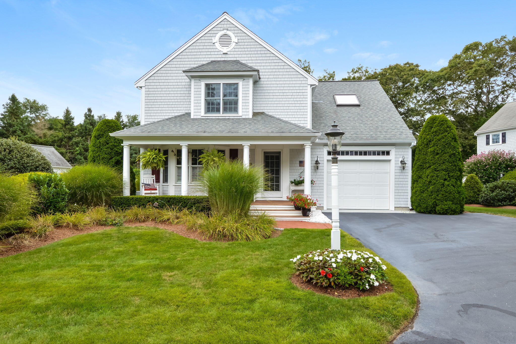 a front view of a house with a garden