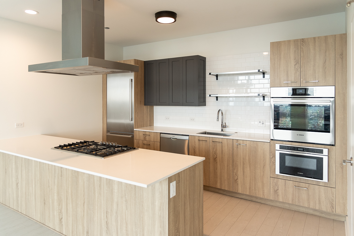 a kitchen with stainless steel appliances a stove a sink and a refrigerator