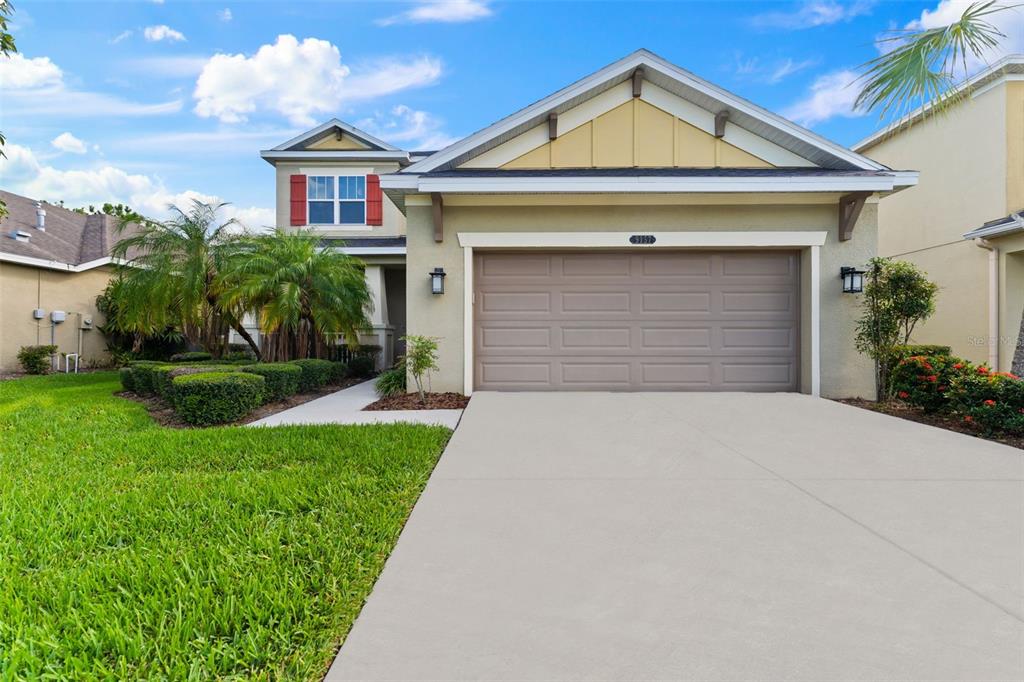 a front view of a house with a yard and garage