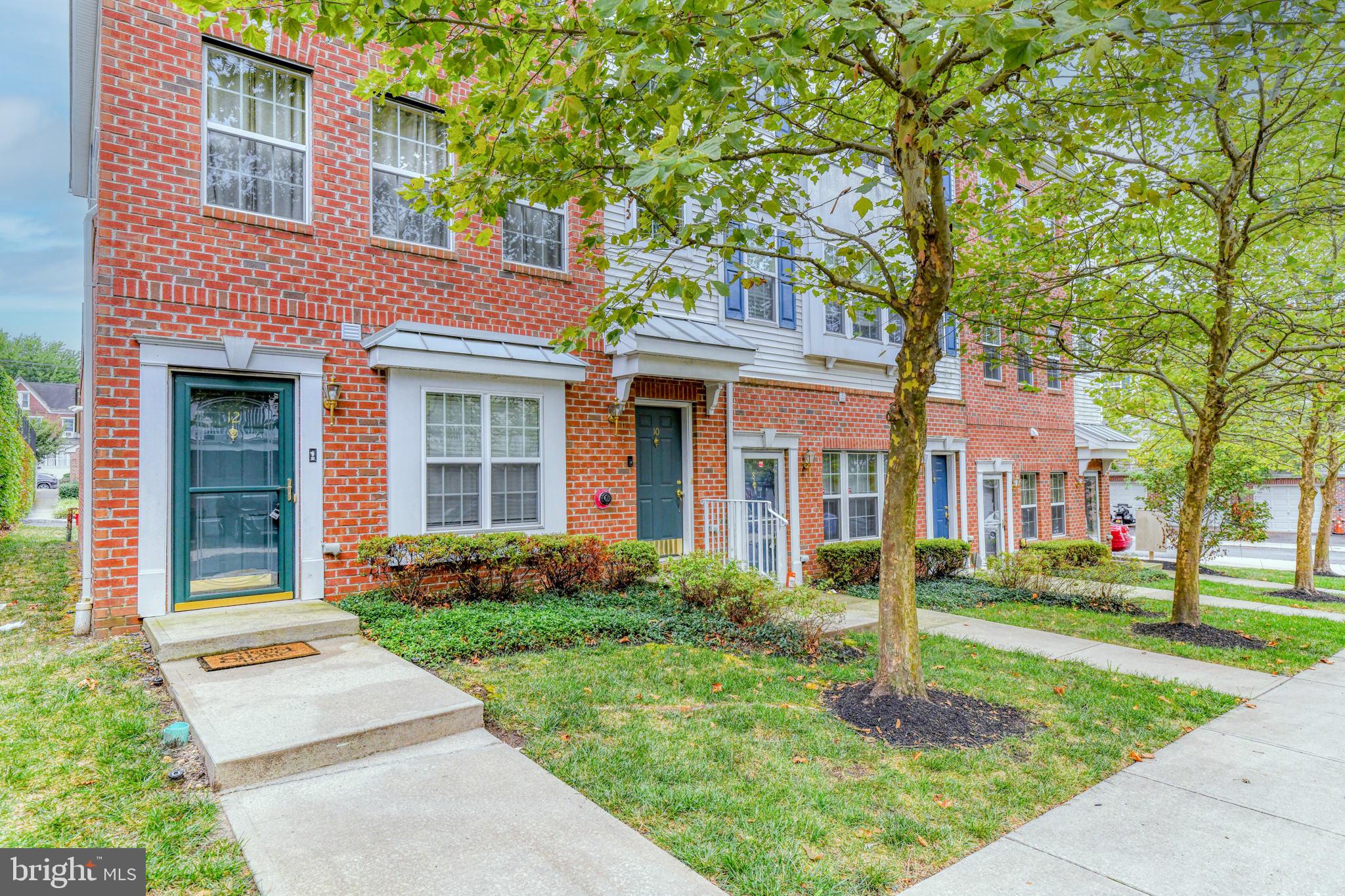 front view of a brick house with a yard