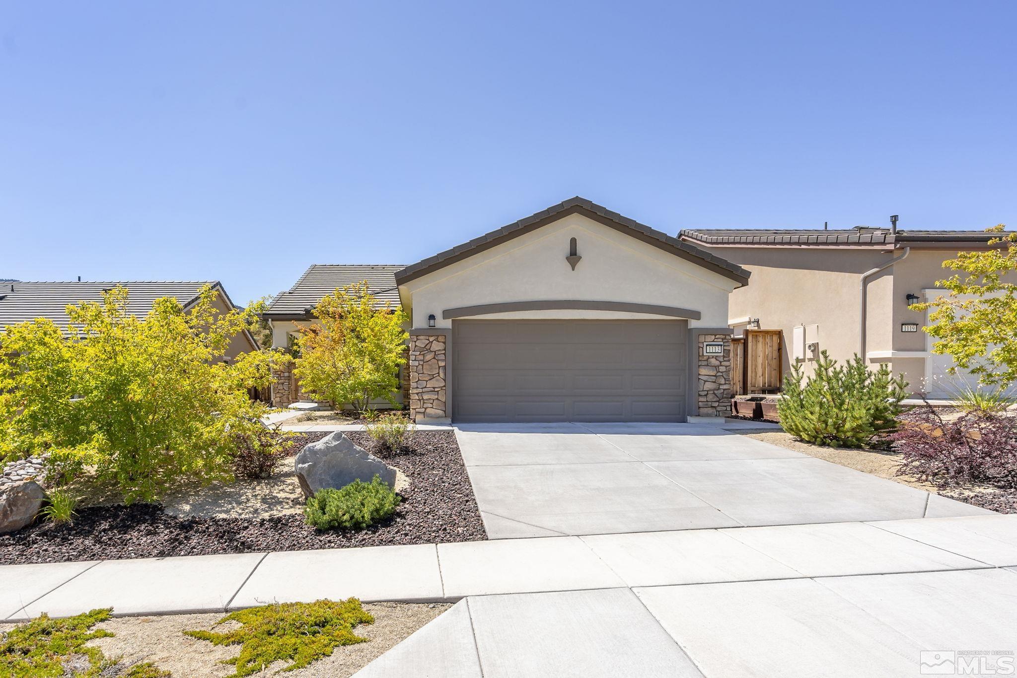 a front view of a house with a yard and garage