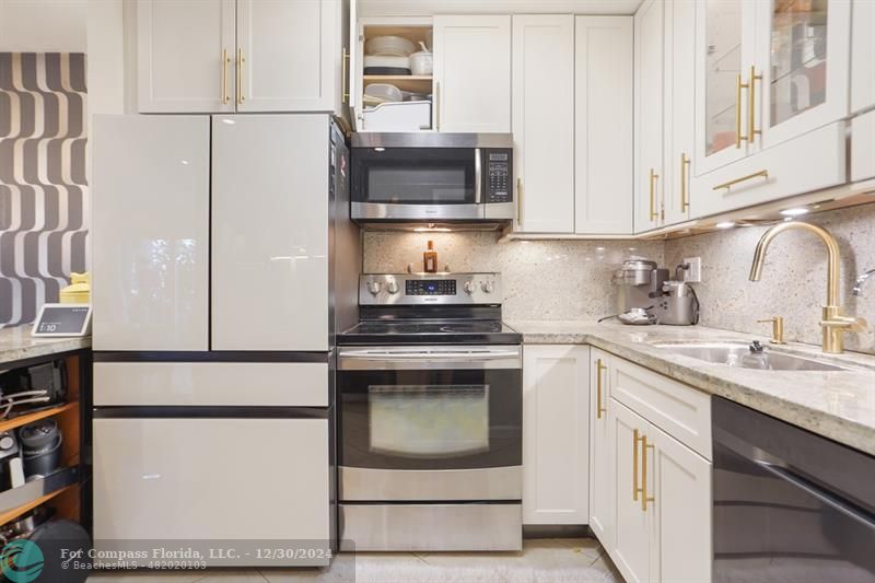 a kitchen with cabinets and white appliances