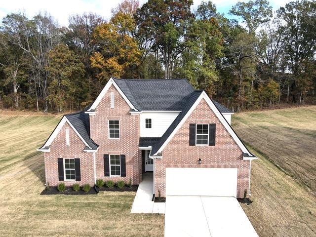 a view of house with yard and entertaining space