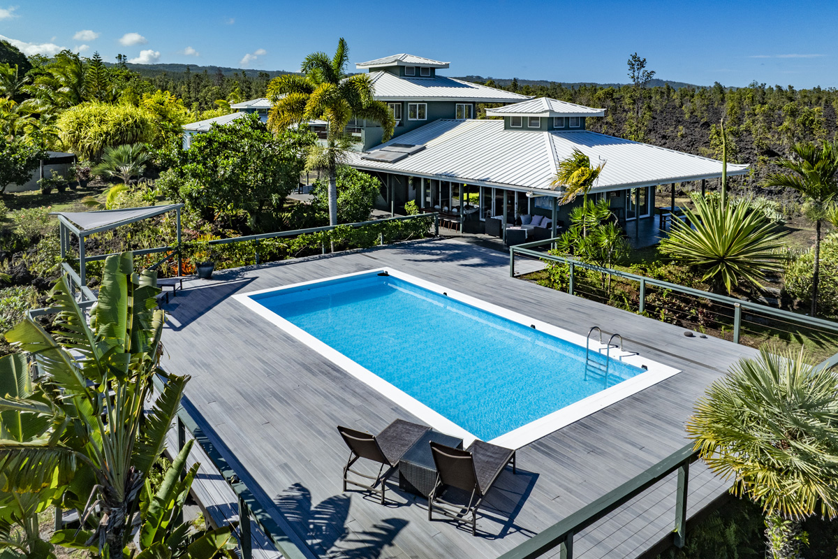 an aerial view of a house with swimming pool patio and outdoor seating