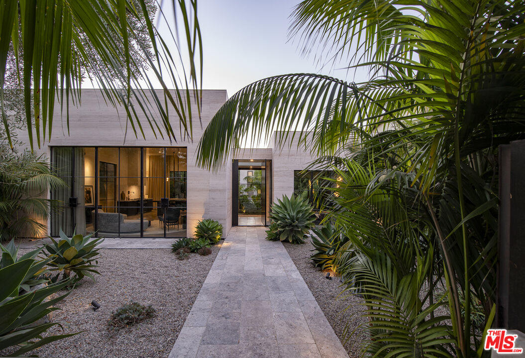 a front view of a house with a garden