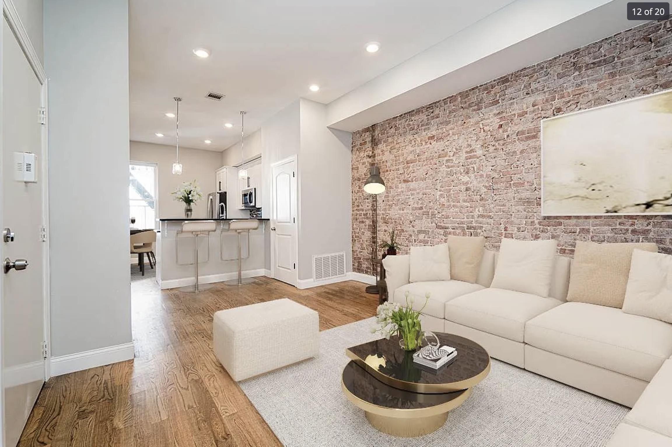 a living room with furniture and a dining table with kitchen view