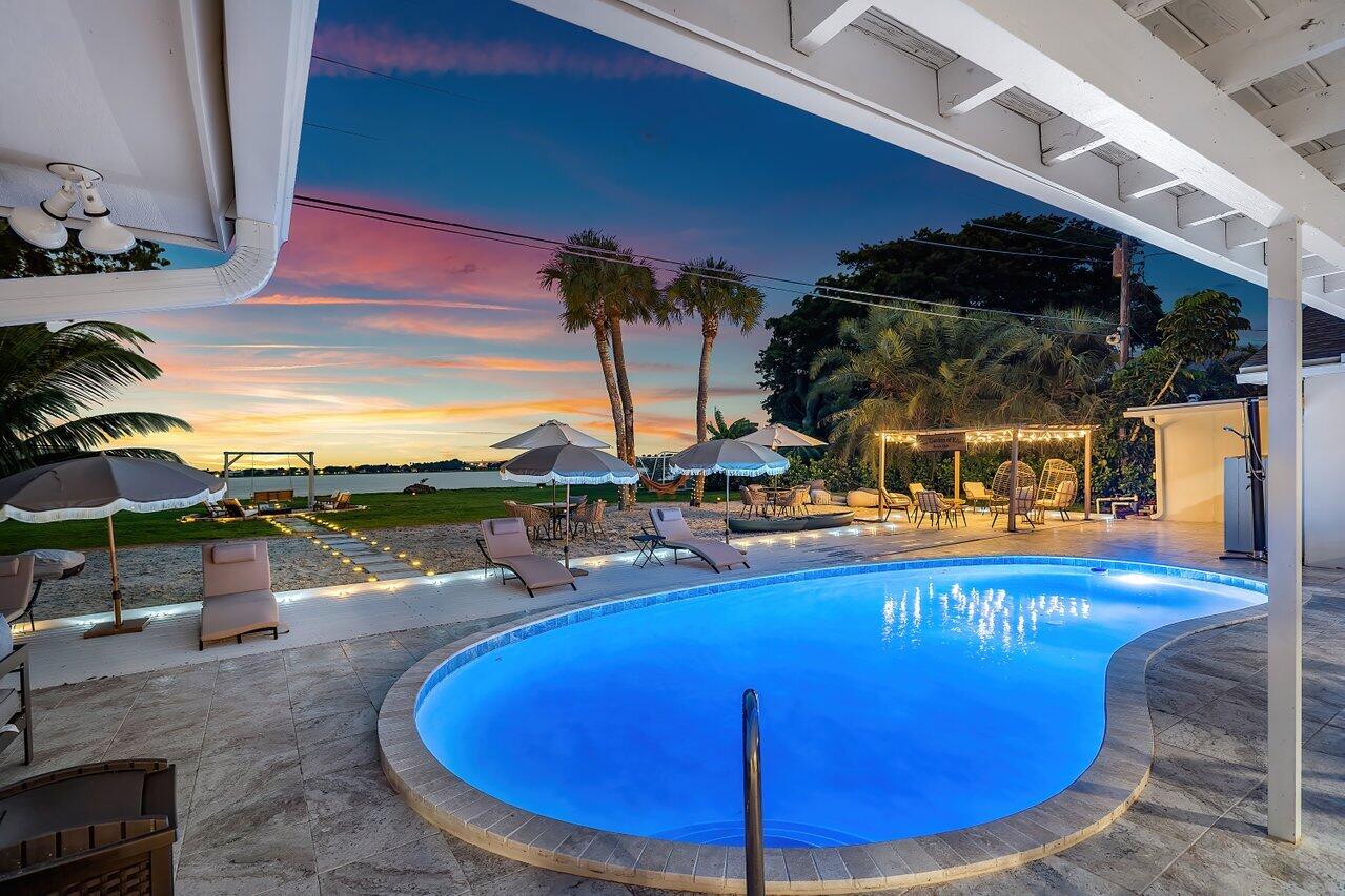 a view of a swimming pool with outdoor seating