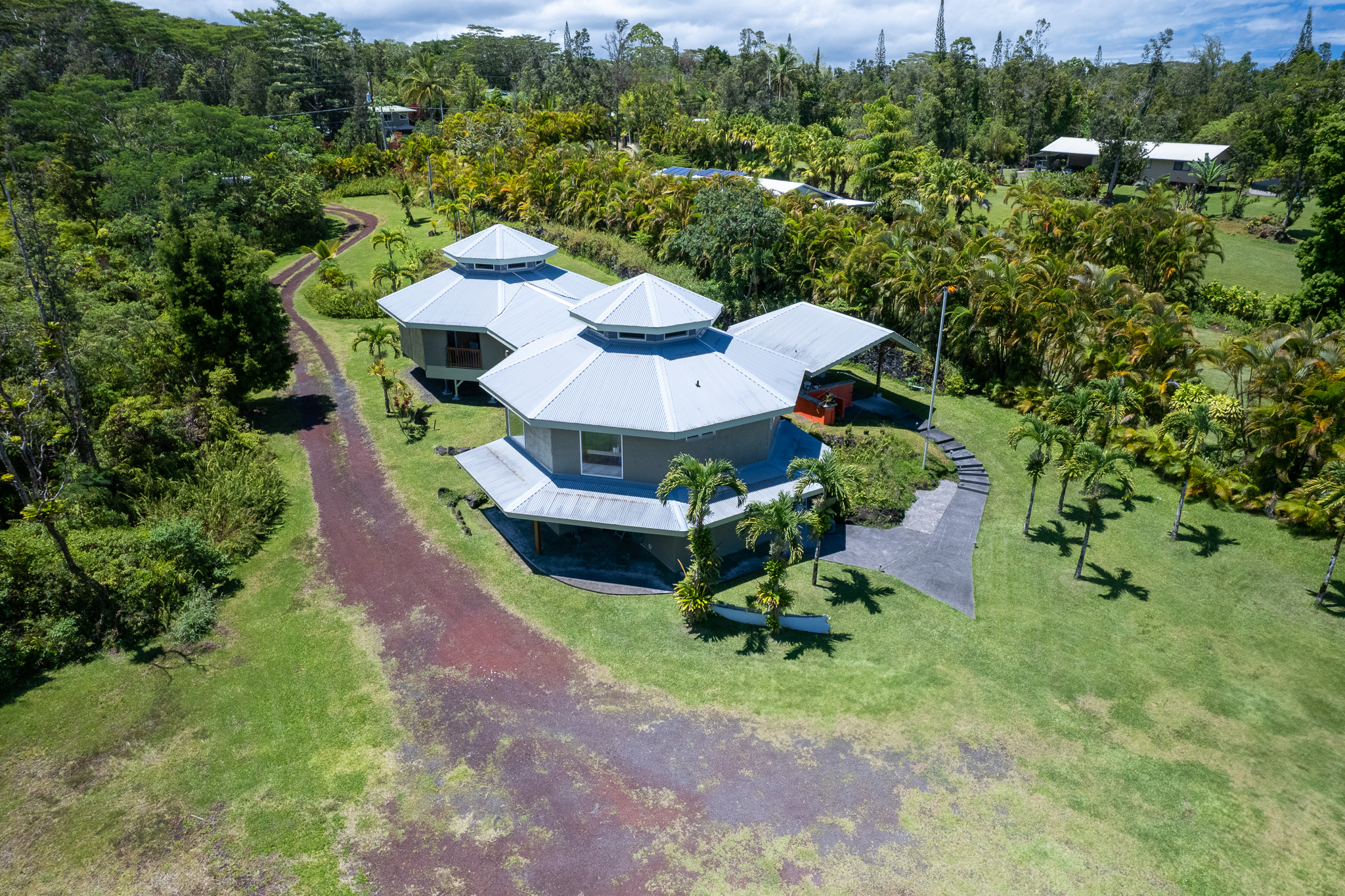 an aerial view of a house with garden space and street view