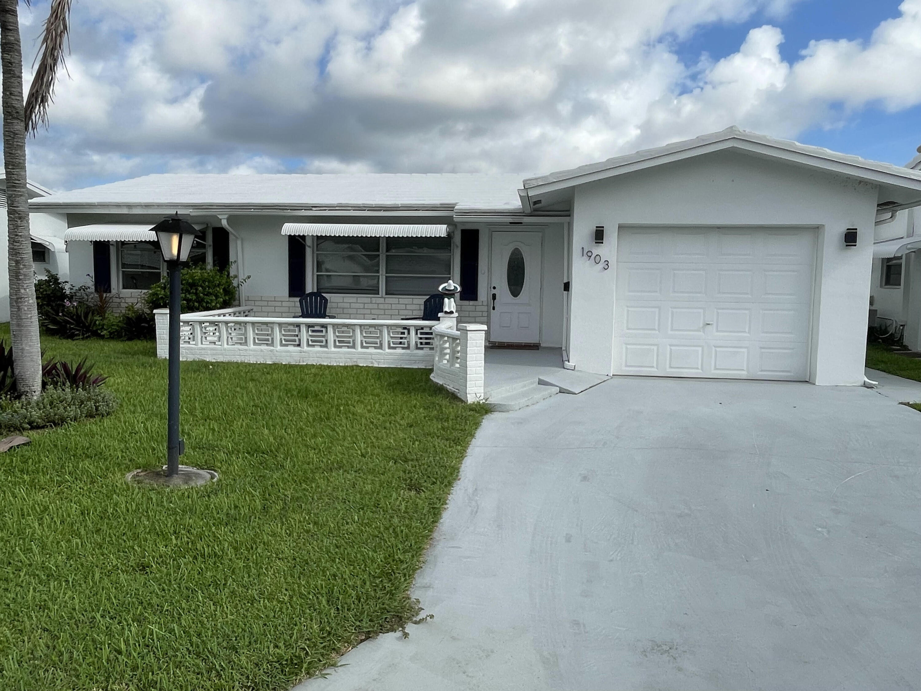 a view of a house with backyard and porch