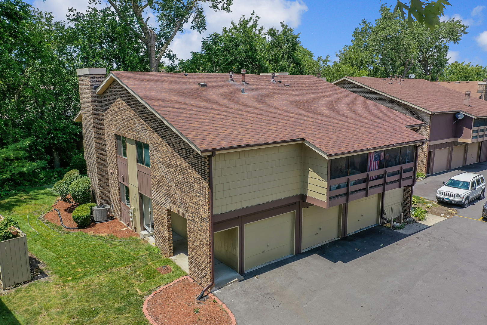 a aerial view of a house with a yard and garage