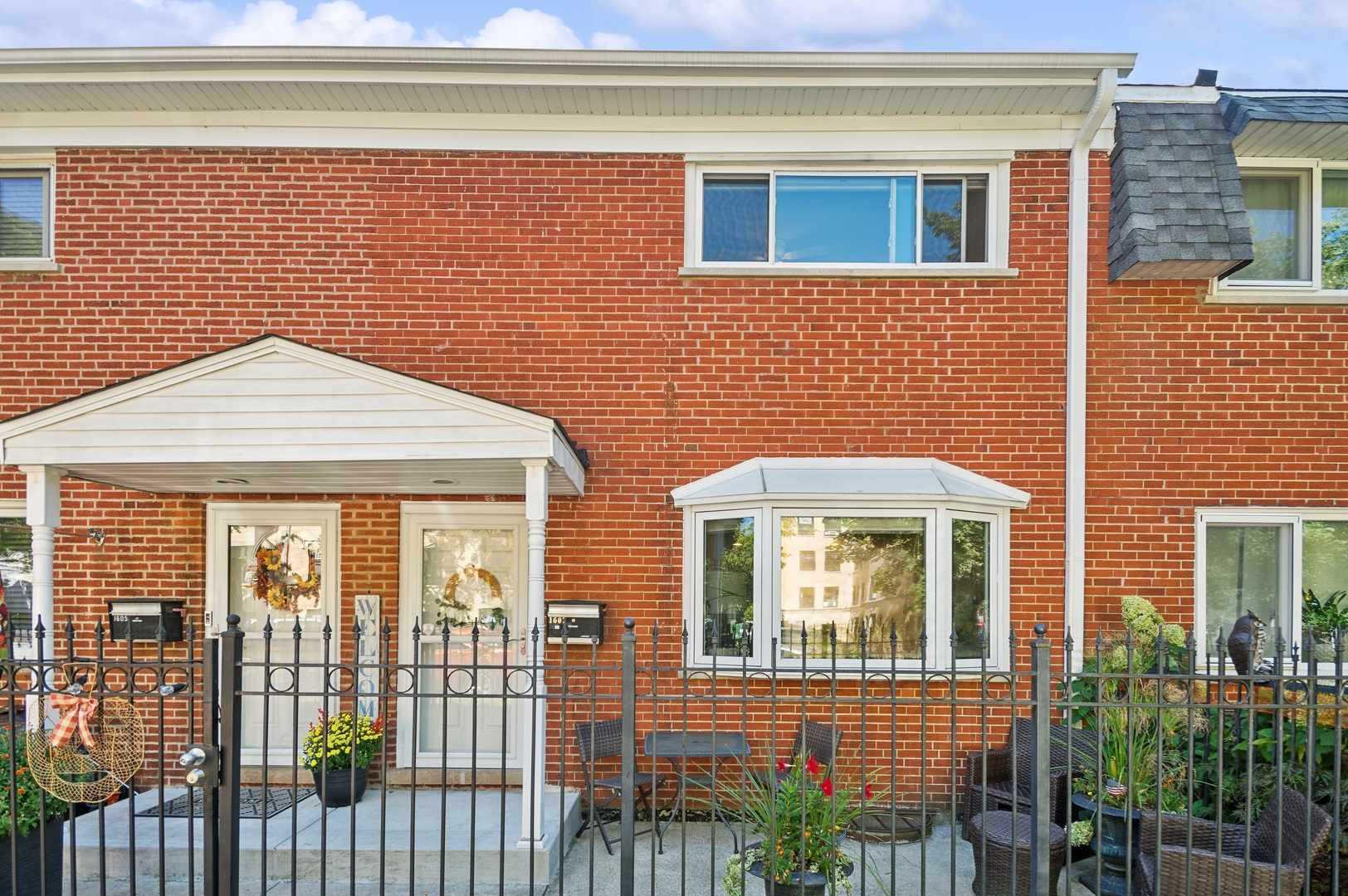 a view of a brick house with large windows