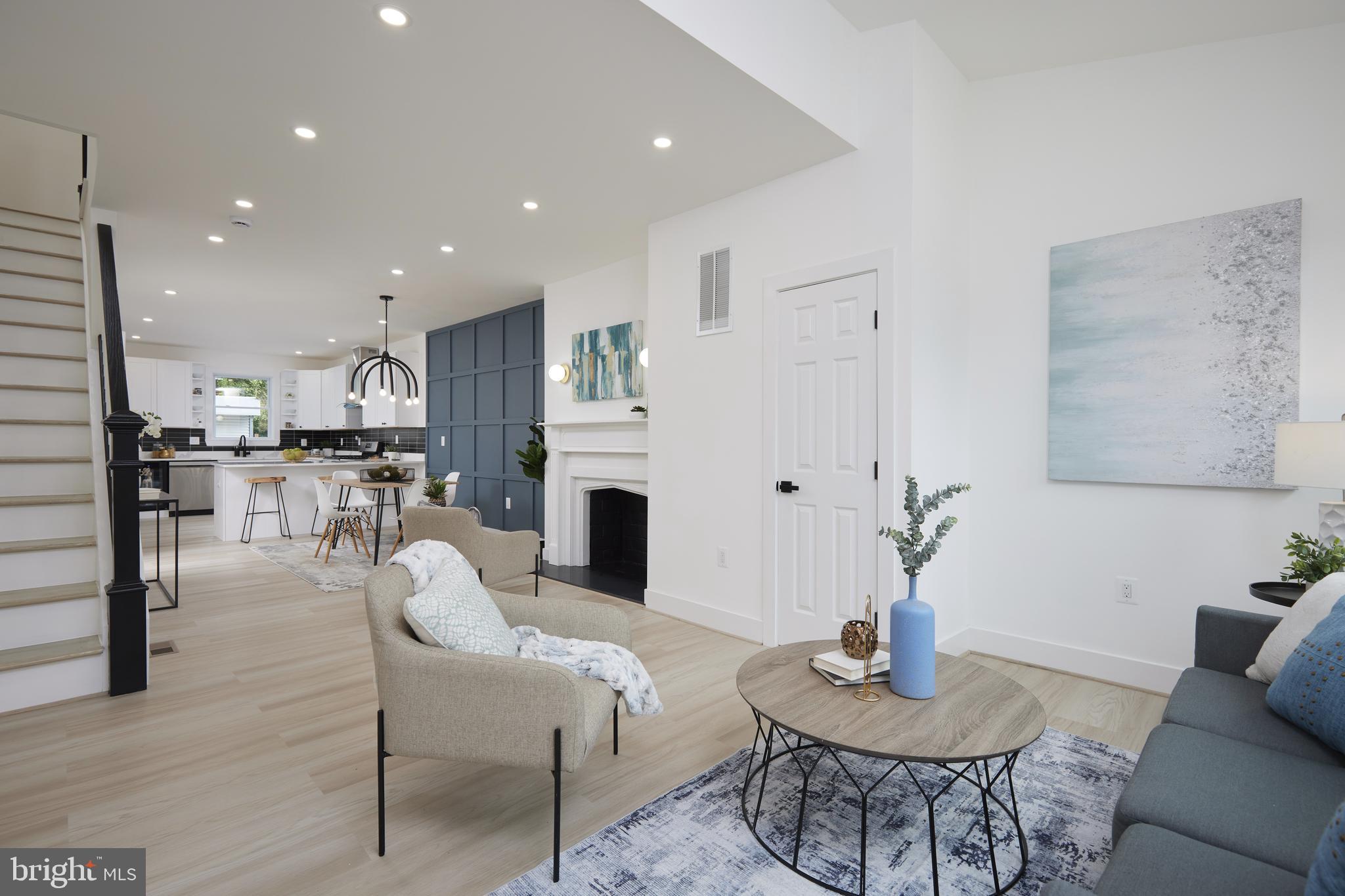 a living room with furniture and a kitchen view