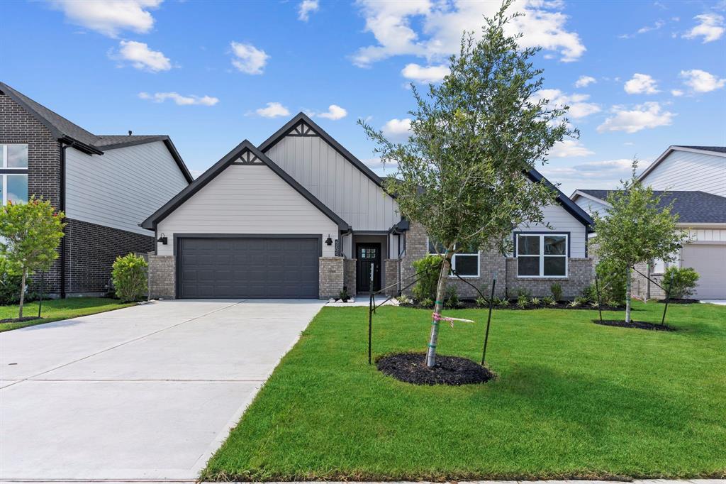 a front view of a house with a yard and a garage