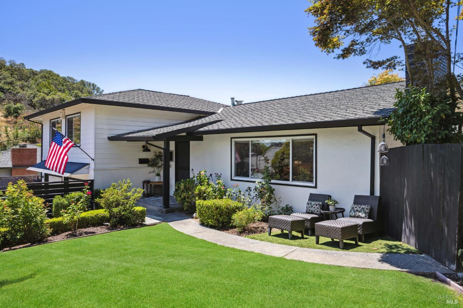 a view of a house with backyard sitting area and garden