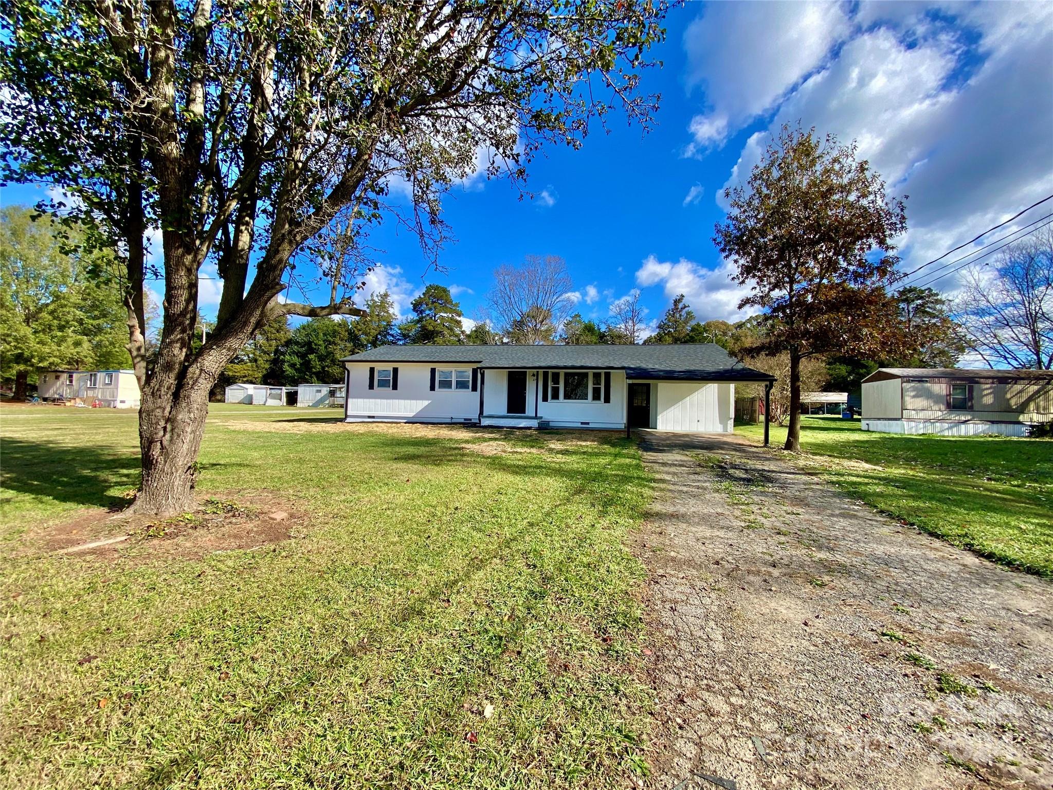 a front view of a house with a big yard