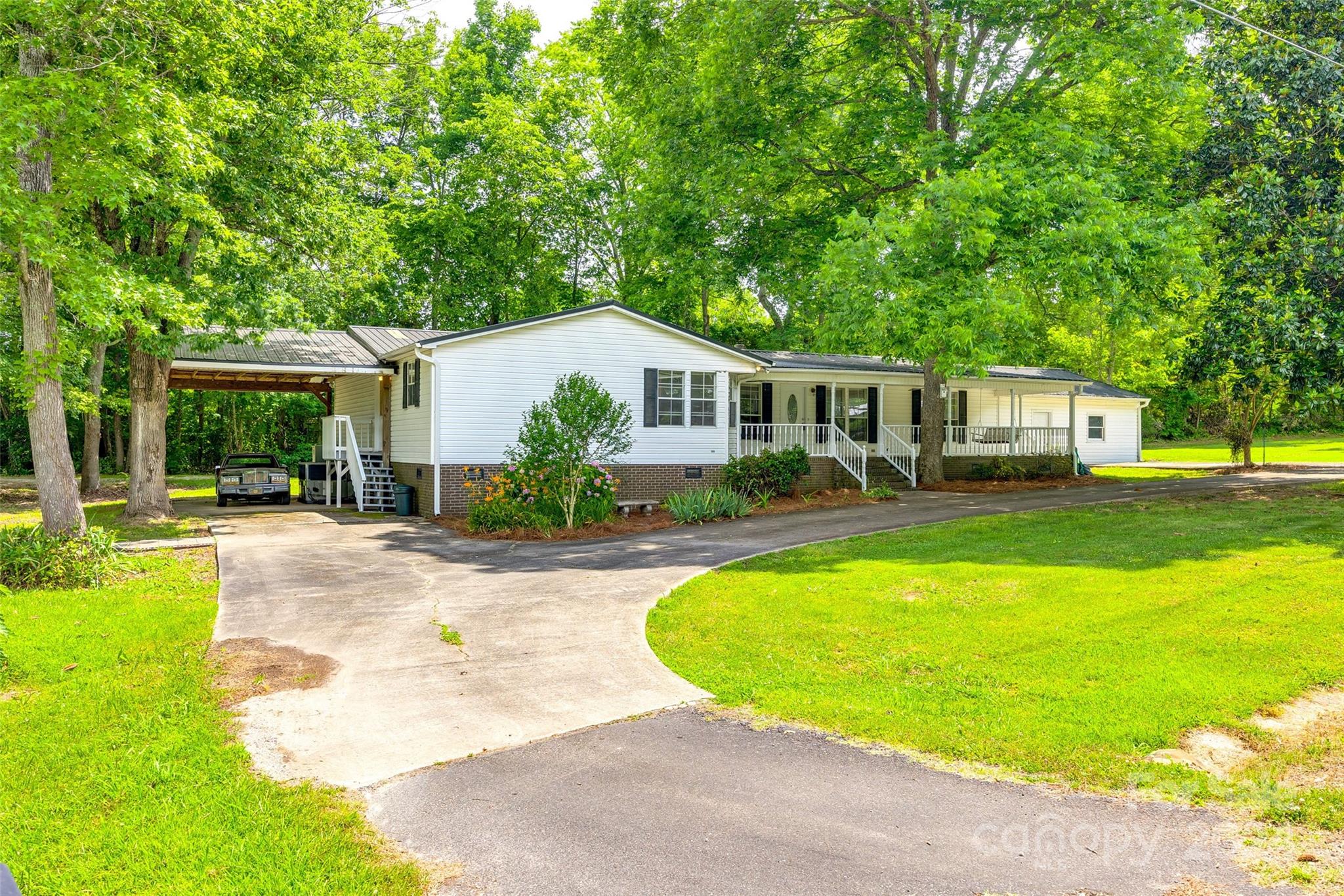 a view of a house with swimming pool and porch