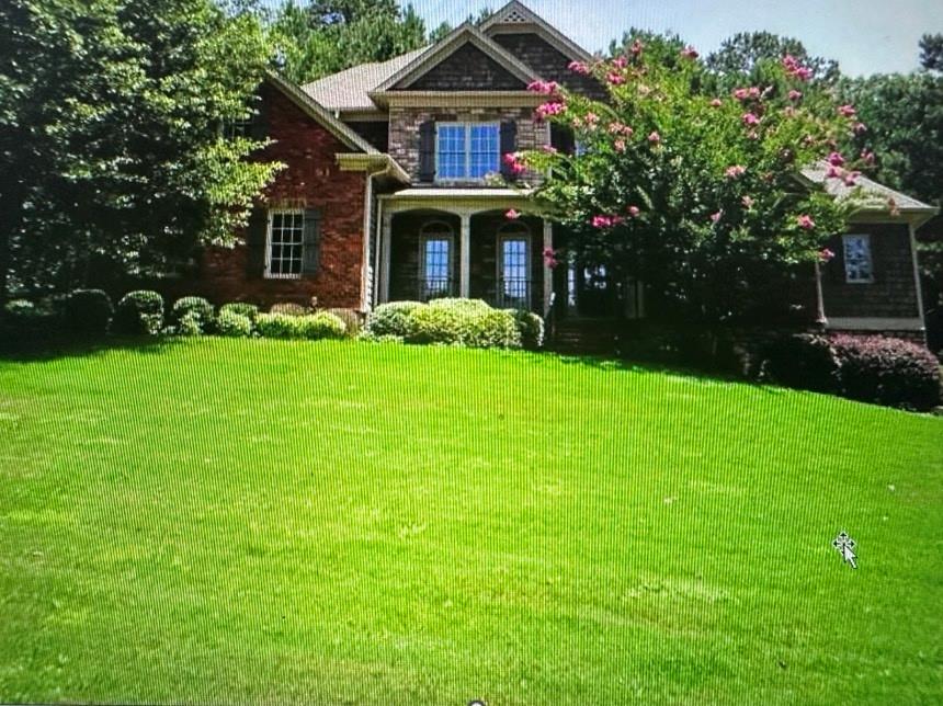 a front view of a house with garden