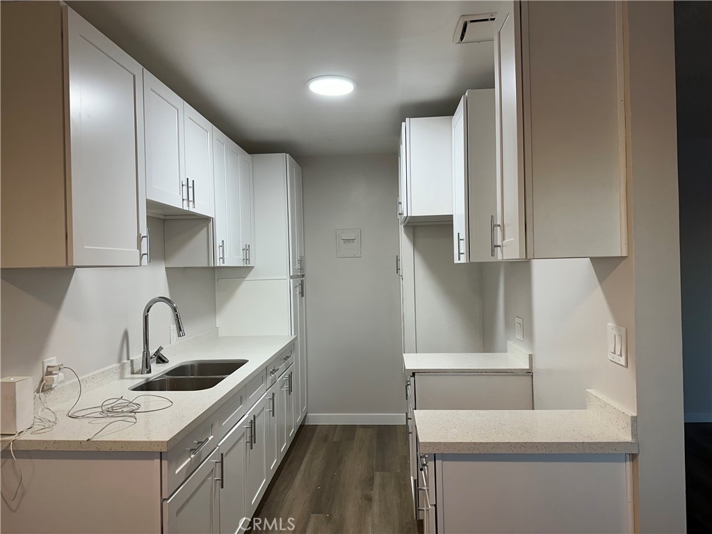 a kitchen with a sink a stove and cabinets