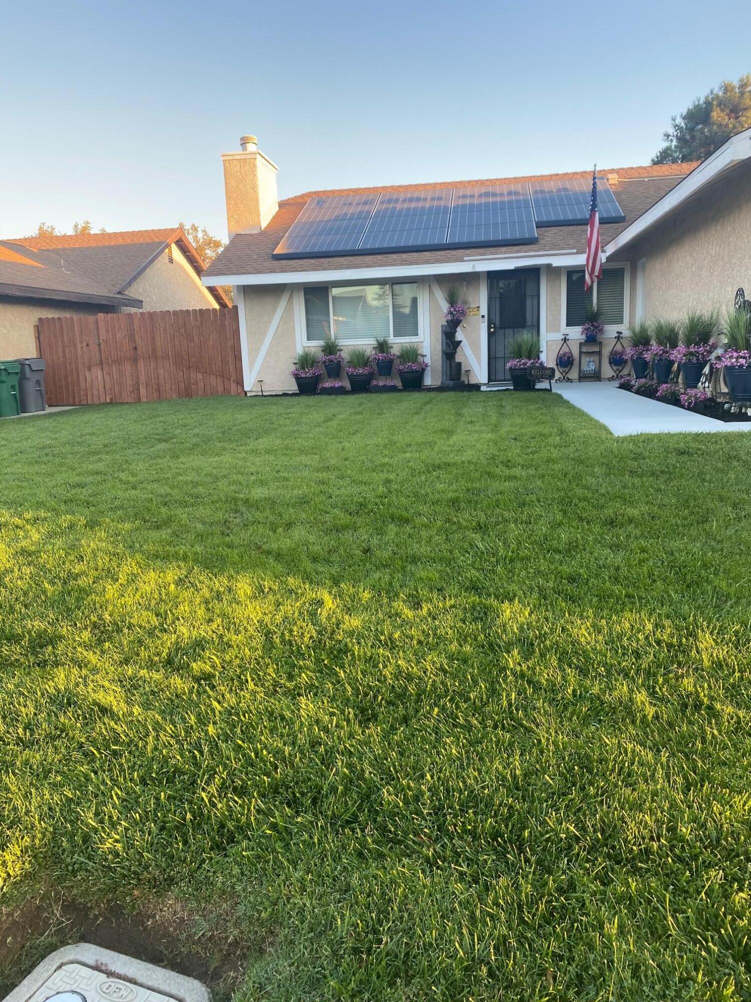 a view of a house with a yard and sitting area