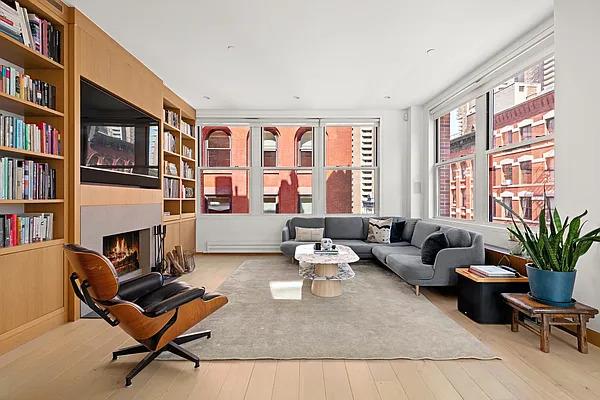 a living room with furniture fireplace and book shelf