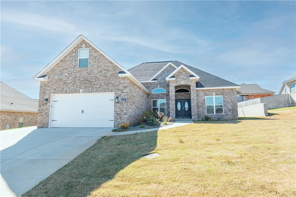 a front view of a house with a yard and garage