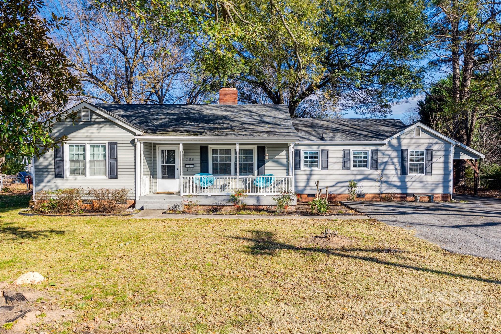 a house that has a tree in front of it