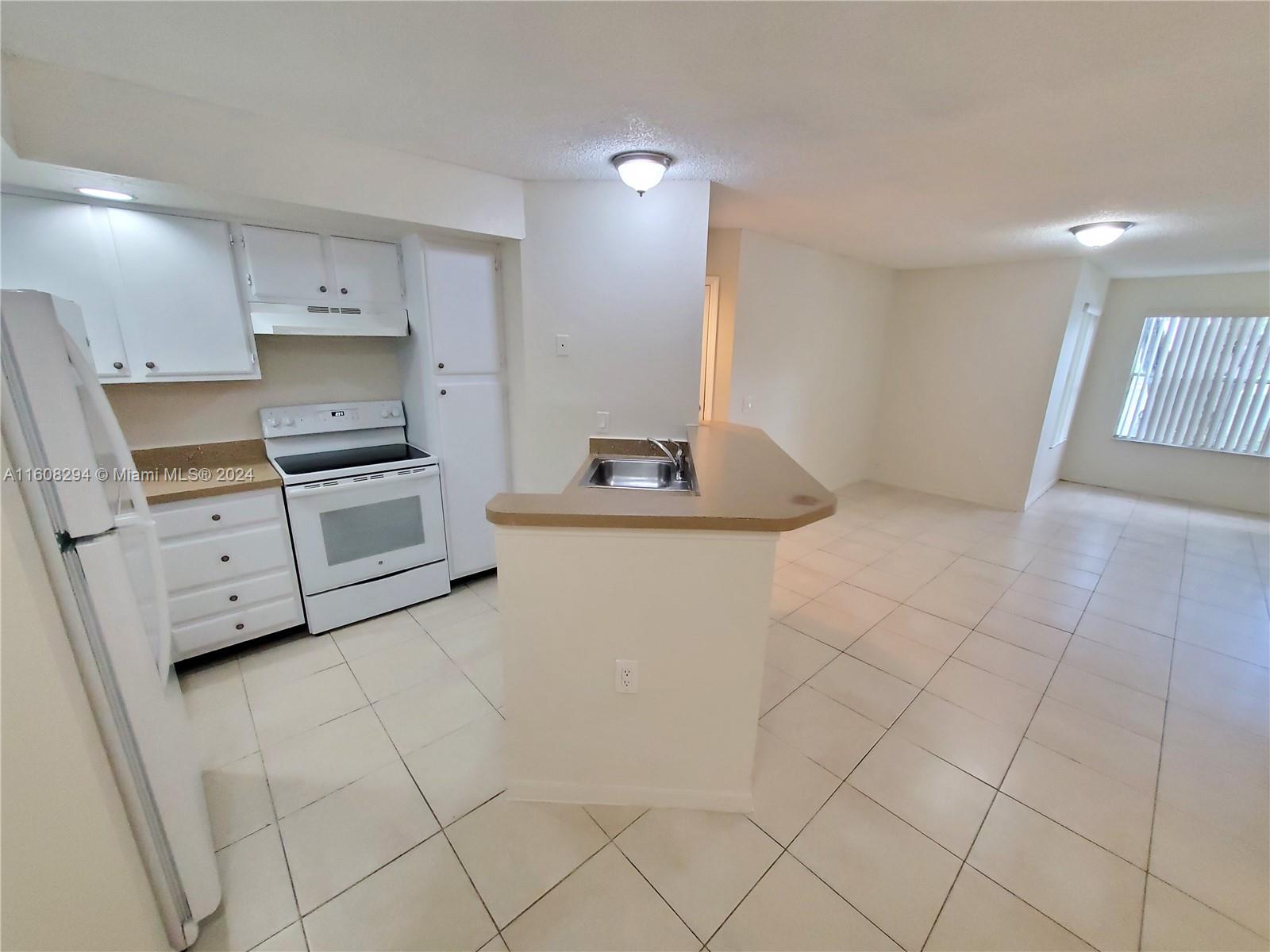 a kitchen with cabinets and appliances