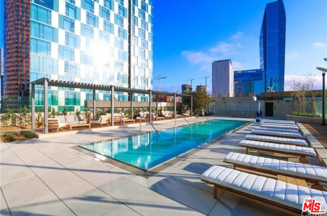 a view of swimming pool with outdoor seating and city view