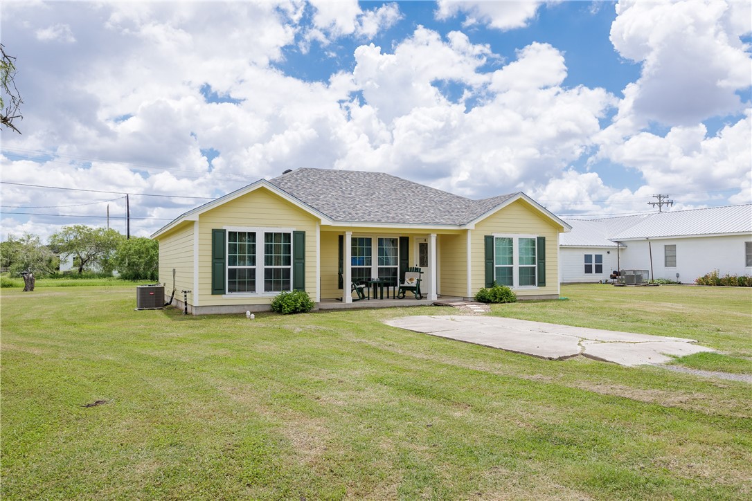 a view of a house with a yard and sitting area