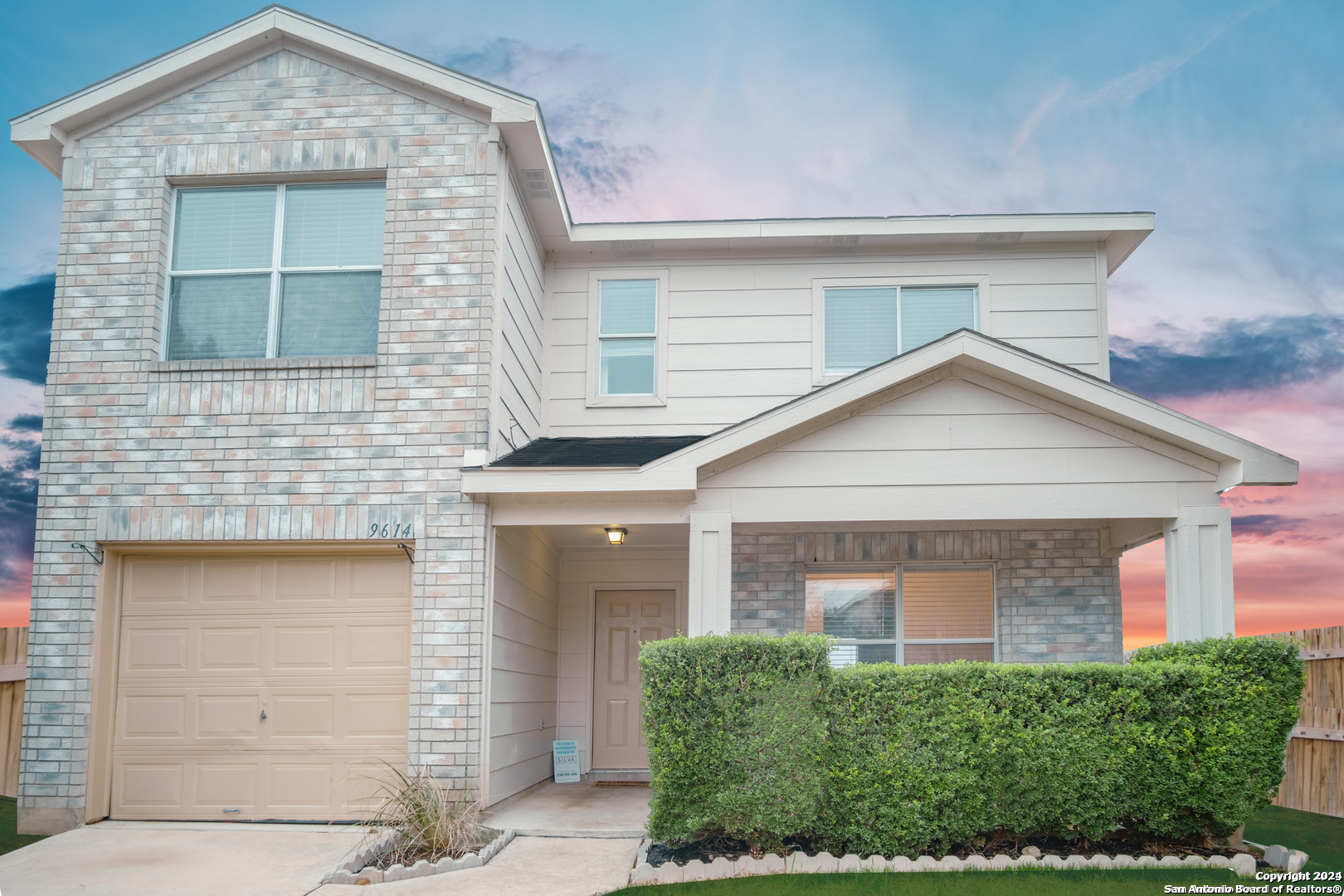 a front view of a house with garage