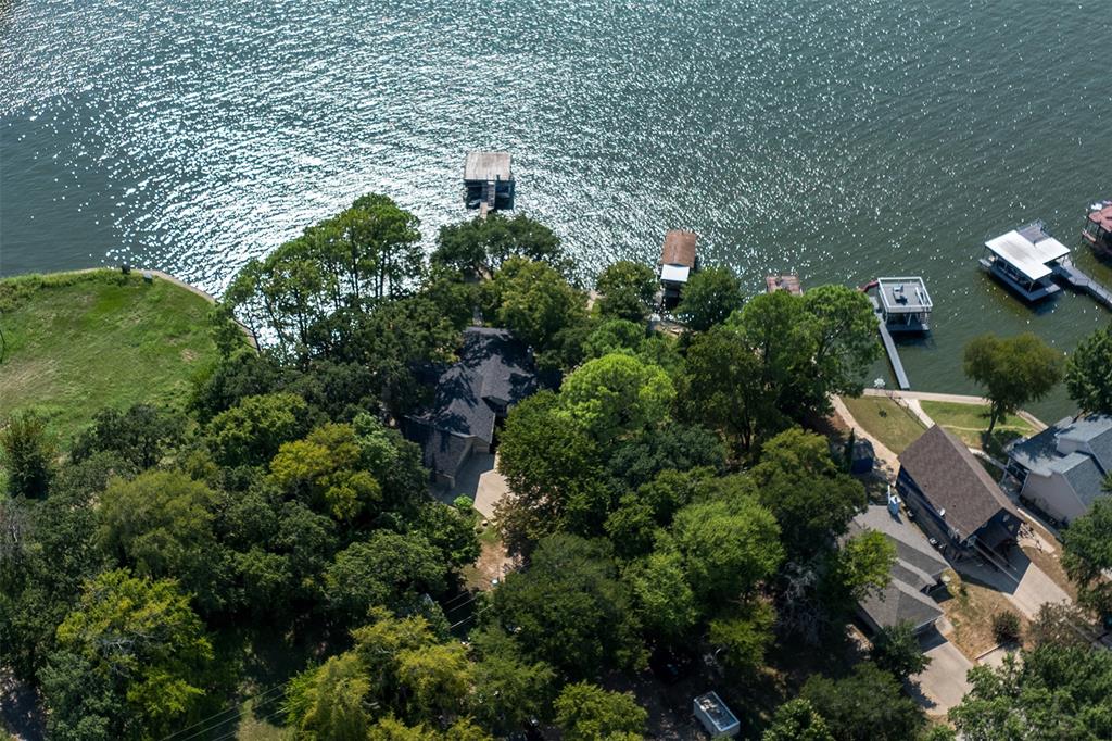 an aerial view of residential house with outdoor space and trees all around