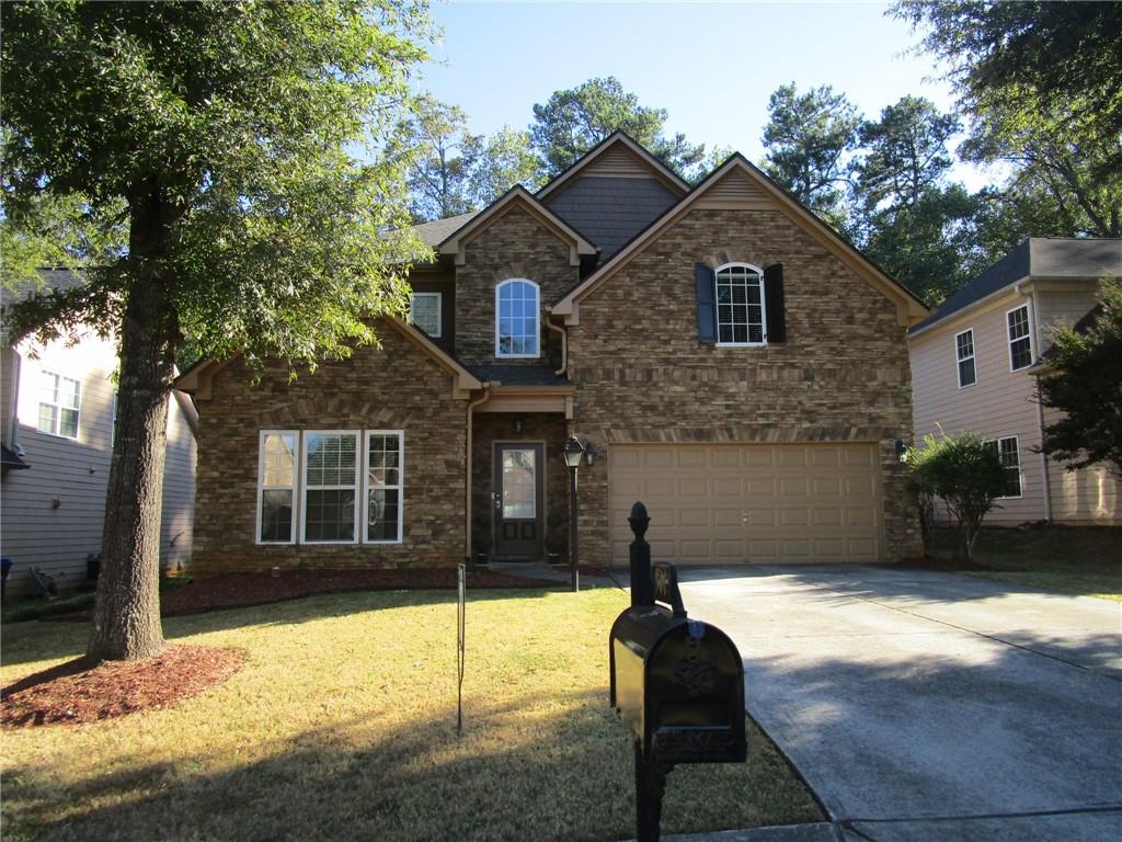 a front view of a house with a yard