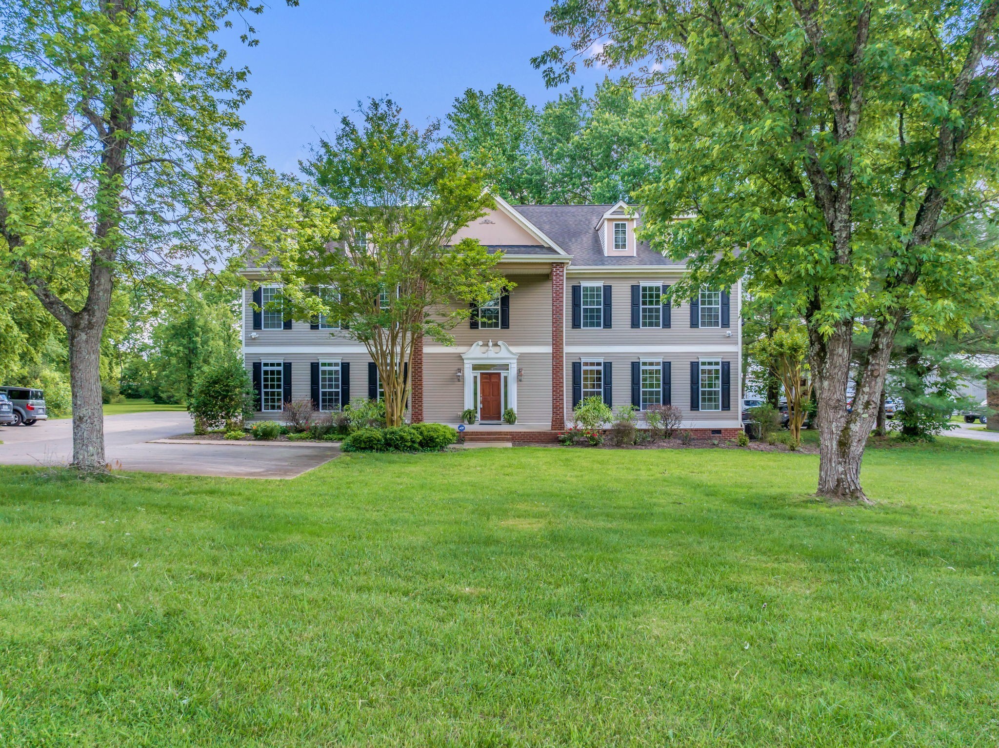 a front view of a house with a garden