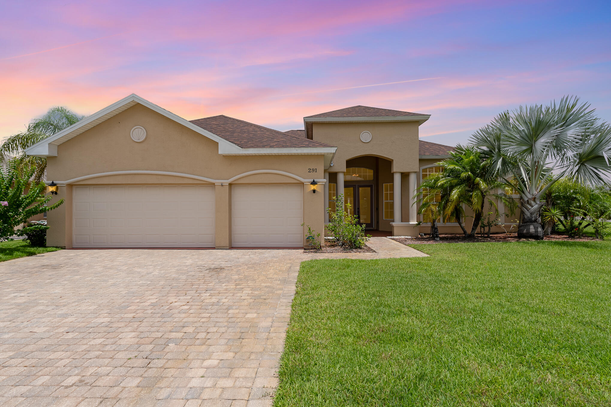 a front view of a house with a yard and garage