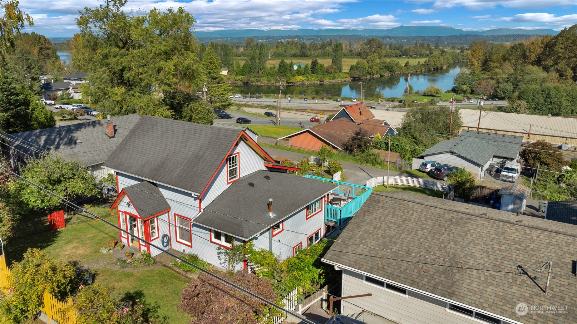 an aerial view of a house with a garden and lake view