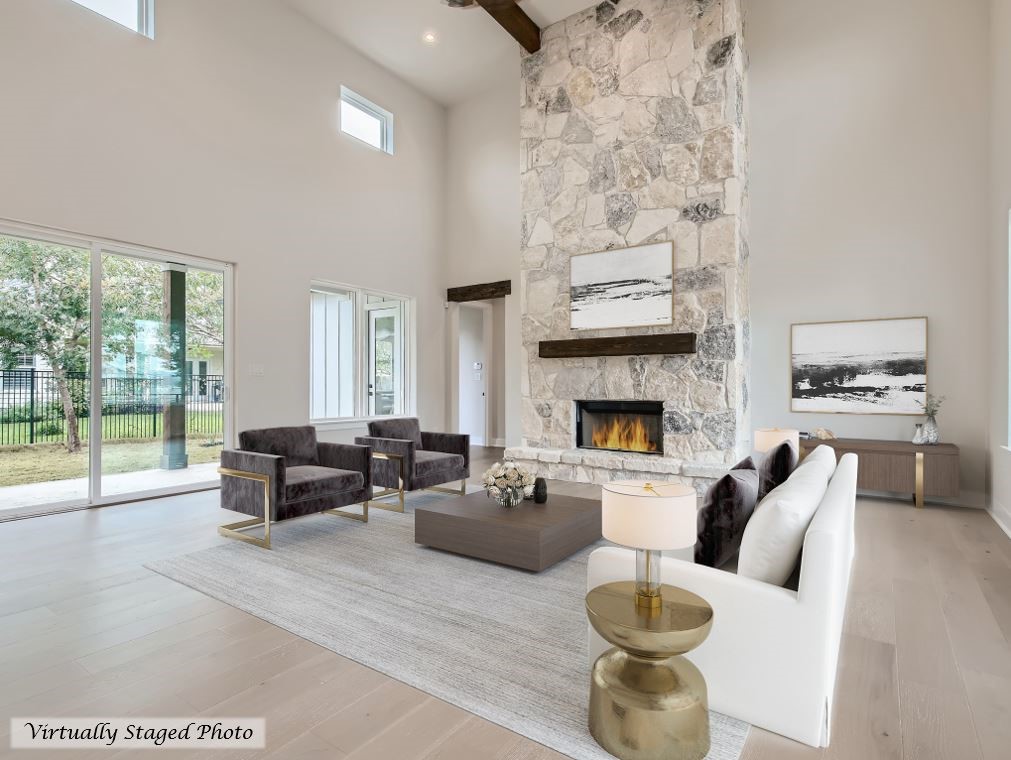 a living room with furniture a fireplace and a floor to ceiling window