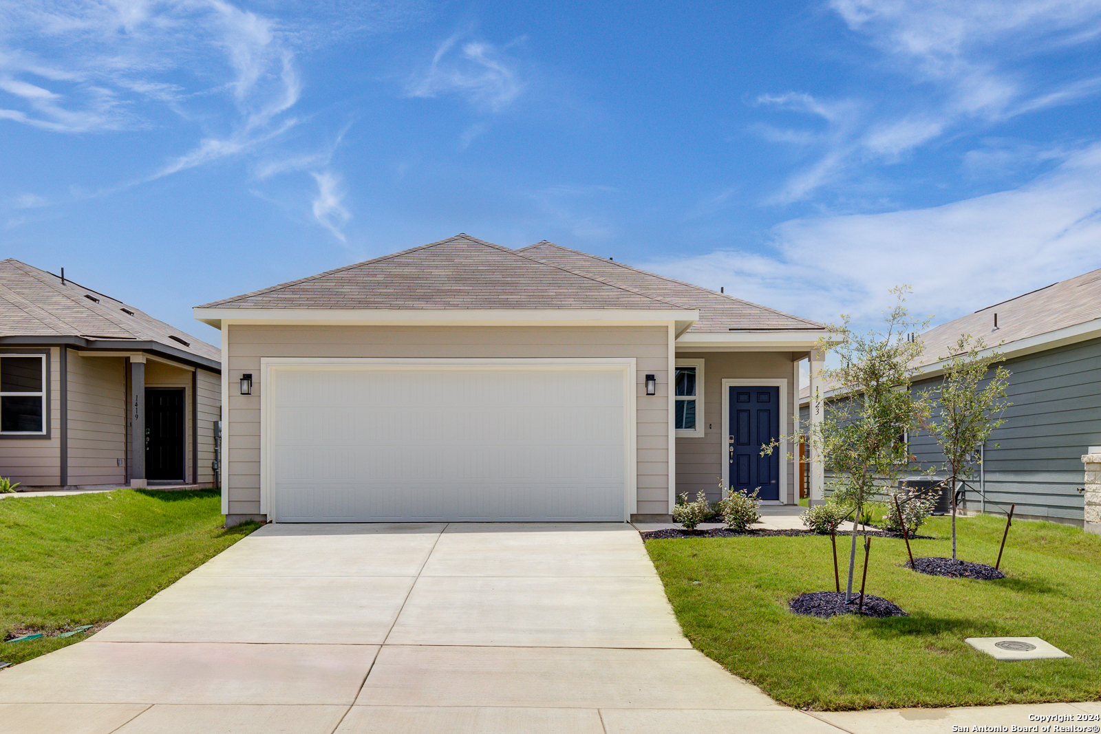 a view of a house with yard and a patio