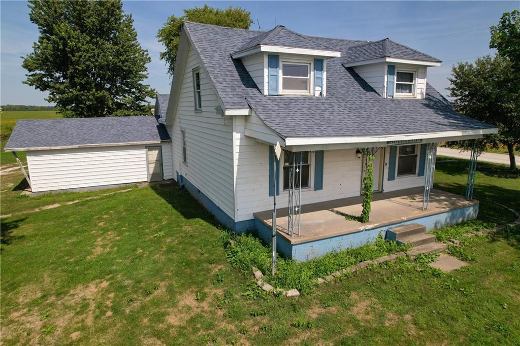 a view of backyard of house with green space