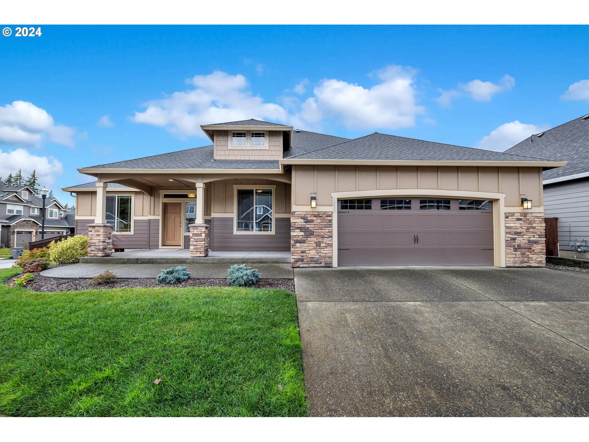 a front view of a house with a yard and garage