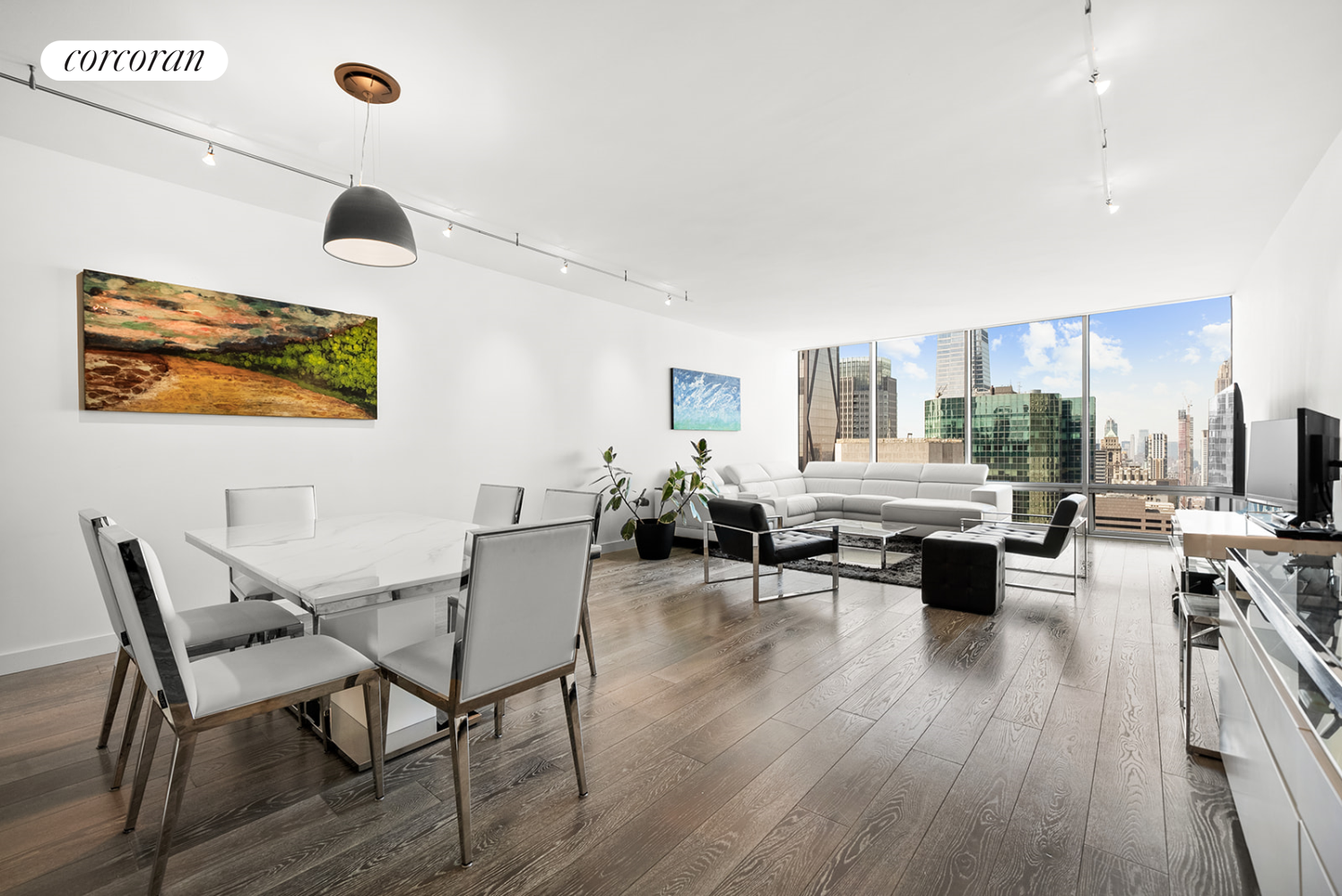 a living room with furniture and wooden floor