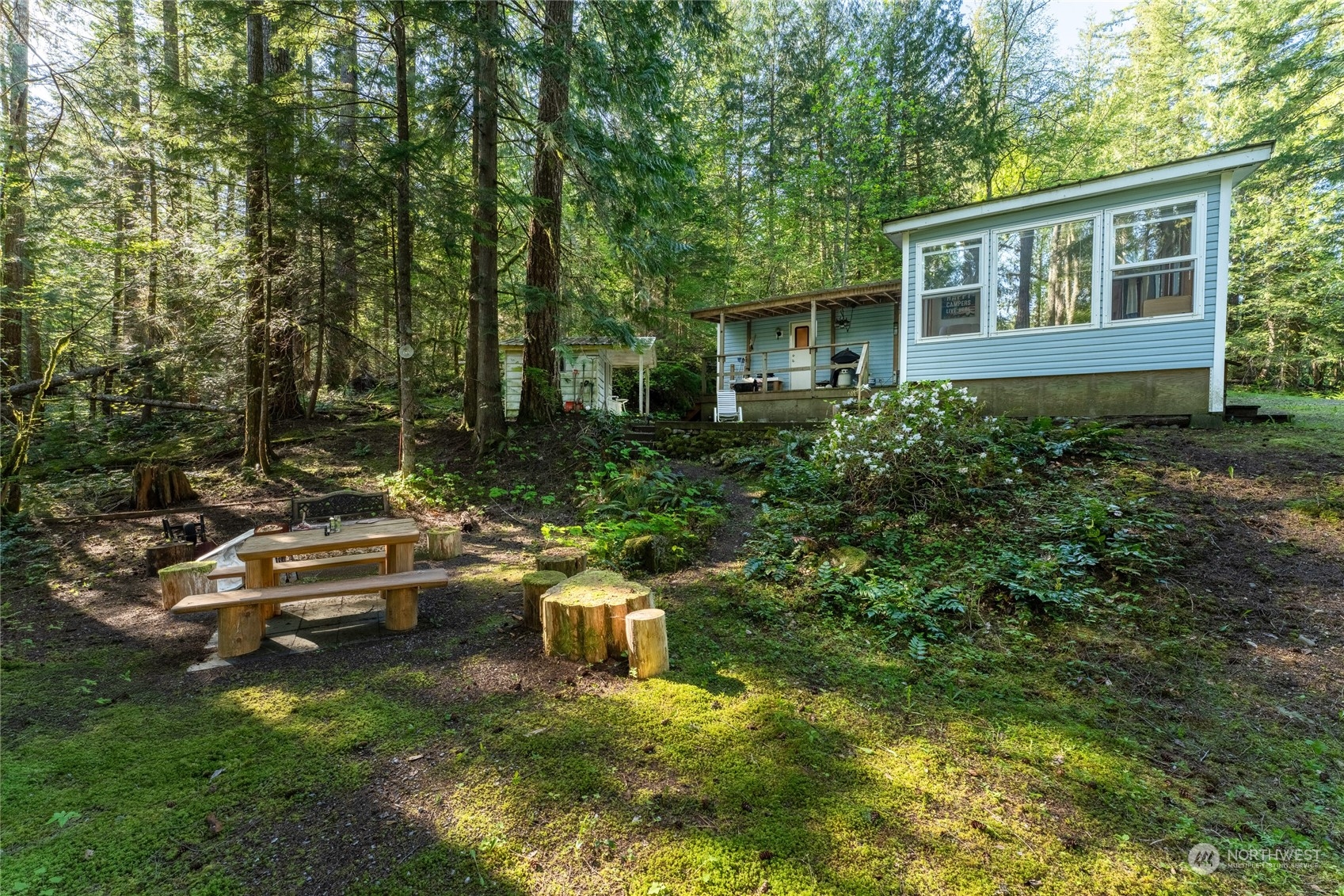 a view of a house with backyard sitting area and garden