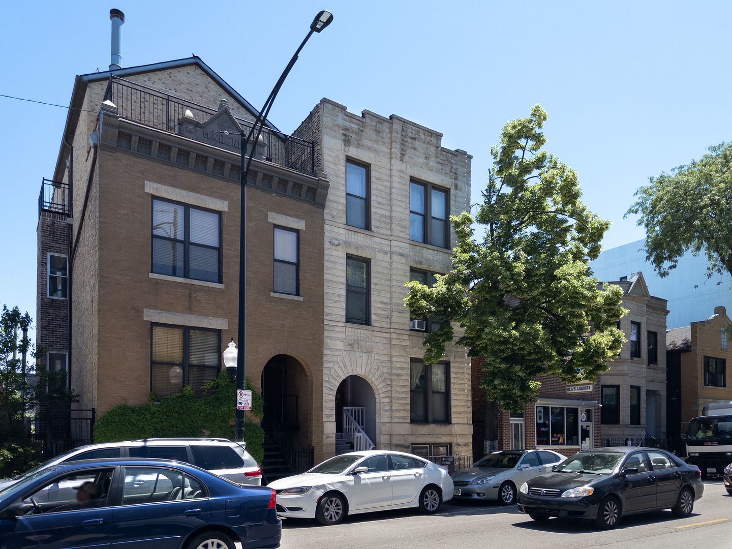 a couple of cars parked in front of a building