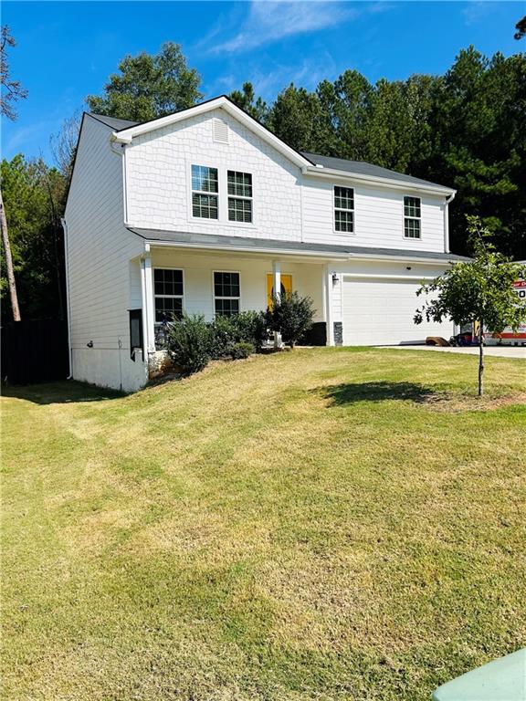 a view of a house with pool and a yard