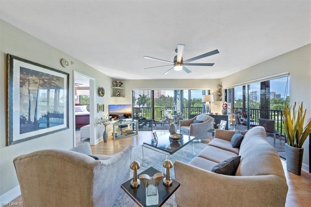 a living room with furniture a large window and a table