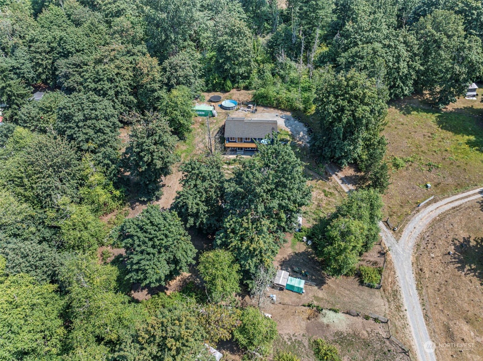 an aerial view of a house with a yard and lake view